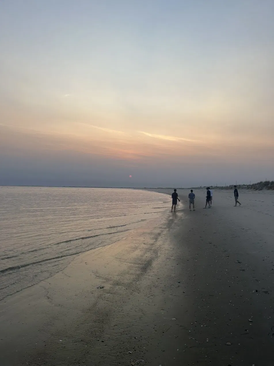 Beach walkers at dusk